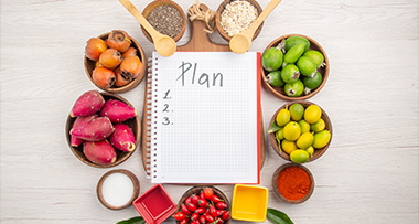 notebook with plan and fresh fruits and vegetables arranged in bowls for meal prep and healthy eating ideas 2 recipes 2 ingredients